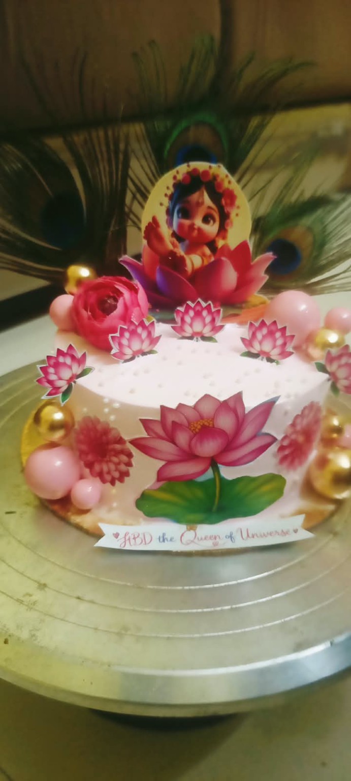 Pink textured birthday cake with playful character detail